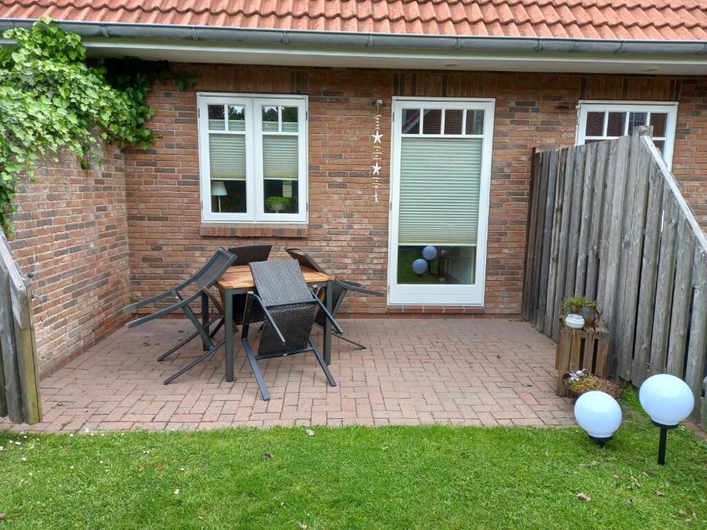 Terrasse mit Sitzgruppe und kleinem Garten